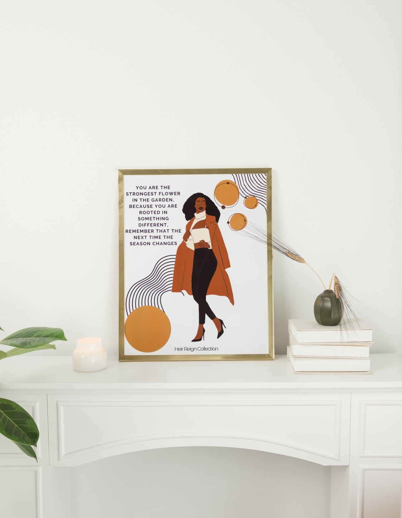 Beautiful wall art illustration of a black business professional woman. She is wearing a brown trench coat, black pants and high heel shoes. The picture also has an inspirational positive affirmation next to the woman. The picture is in a gold frame with beautiful home decor.