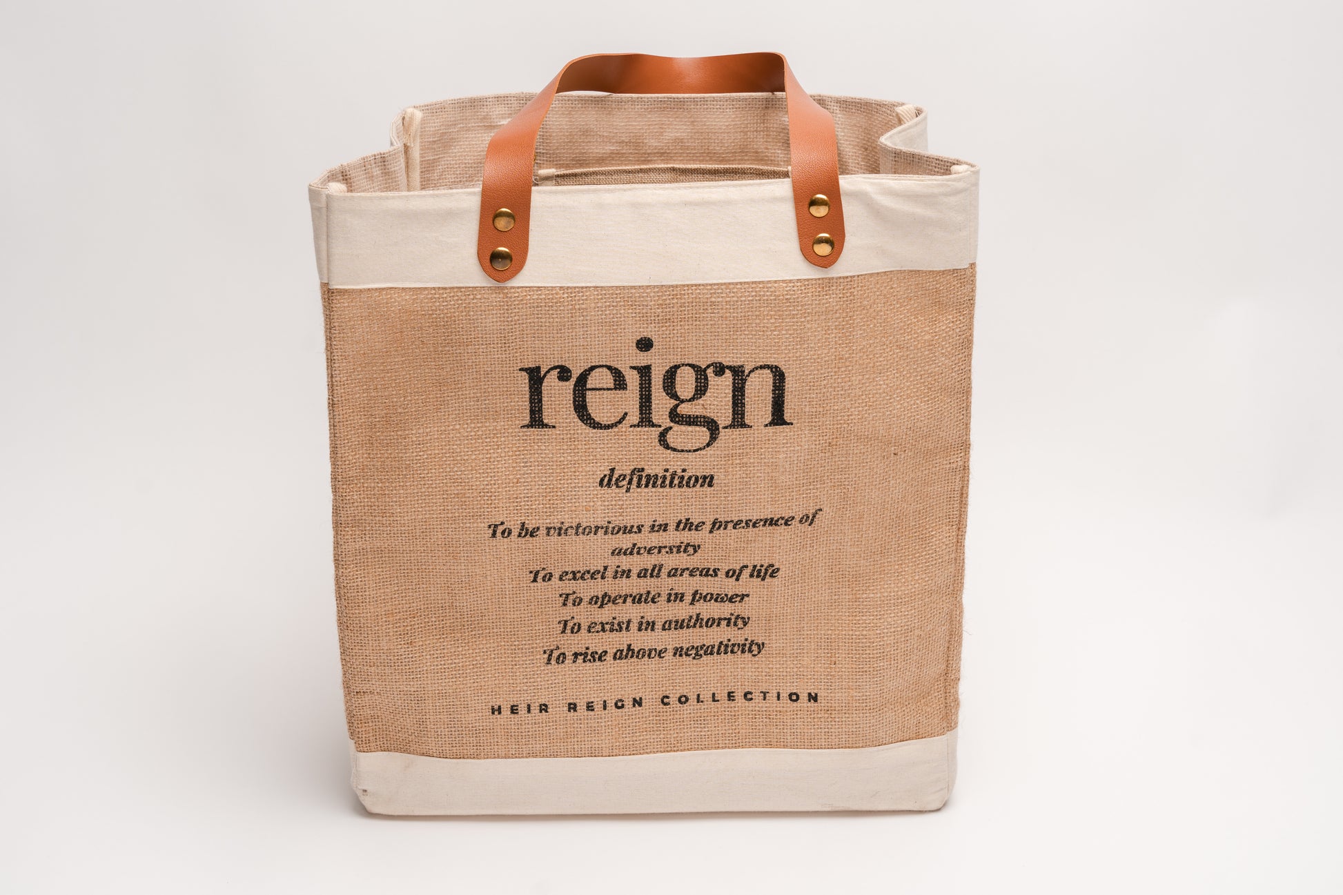 This is a picture of a burlap tote bag with a positive affirmation quote on the front. 