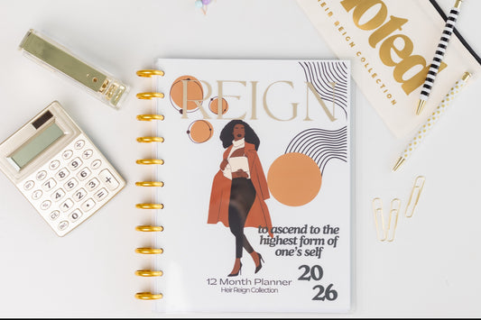 Planner with a cover featuring a woman and text, surrounded by office supplies on a light background. Reign Elegance 12-Month Planner with illustrated Black woman in coat
2026 refillable disc-bound planner featuring confident Black woman illustration